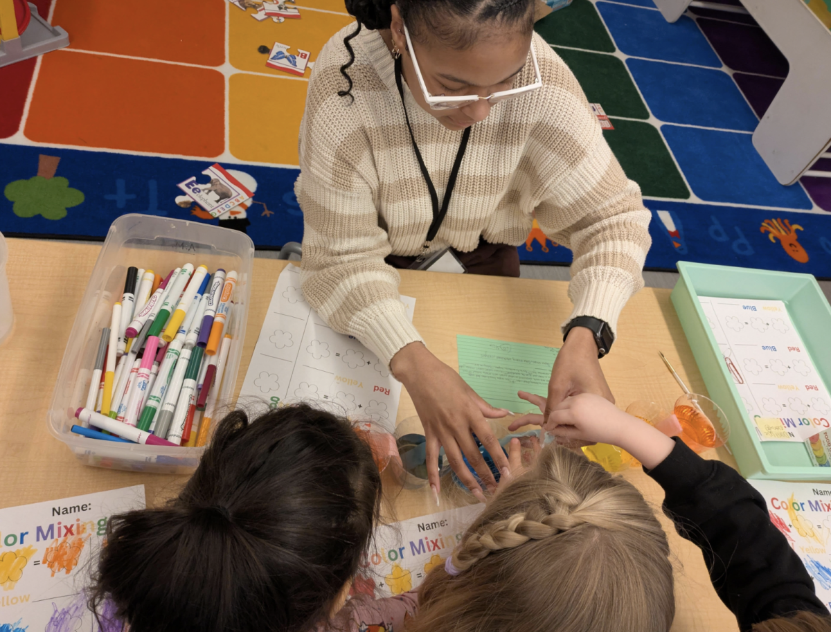 Senior Gyilenn Arce doing hands on learning with the preschoolers