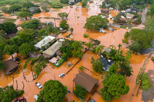 Hawaiian neighborhood flooded with water and volcanic sediment
